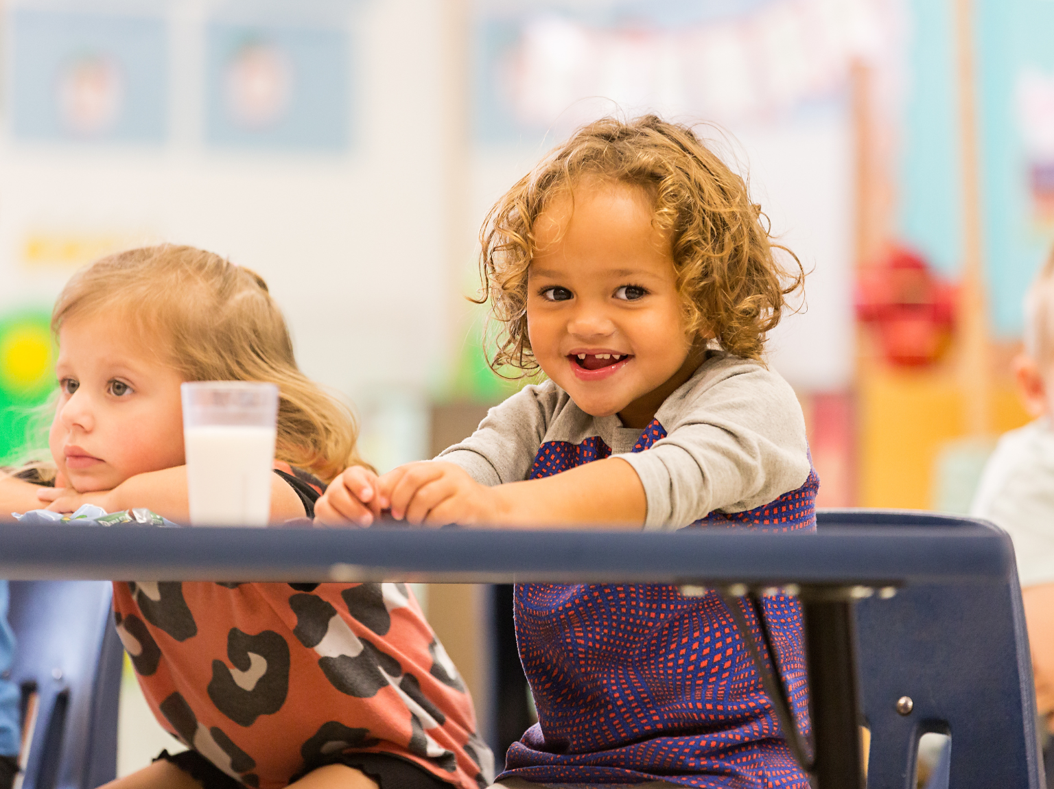 Zion ELC a child is drawing on a piece of paper