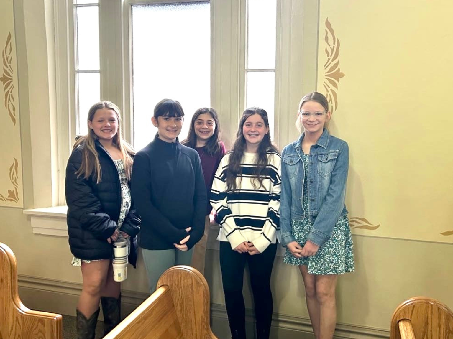 Youth three men and laughing two women walking side by side