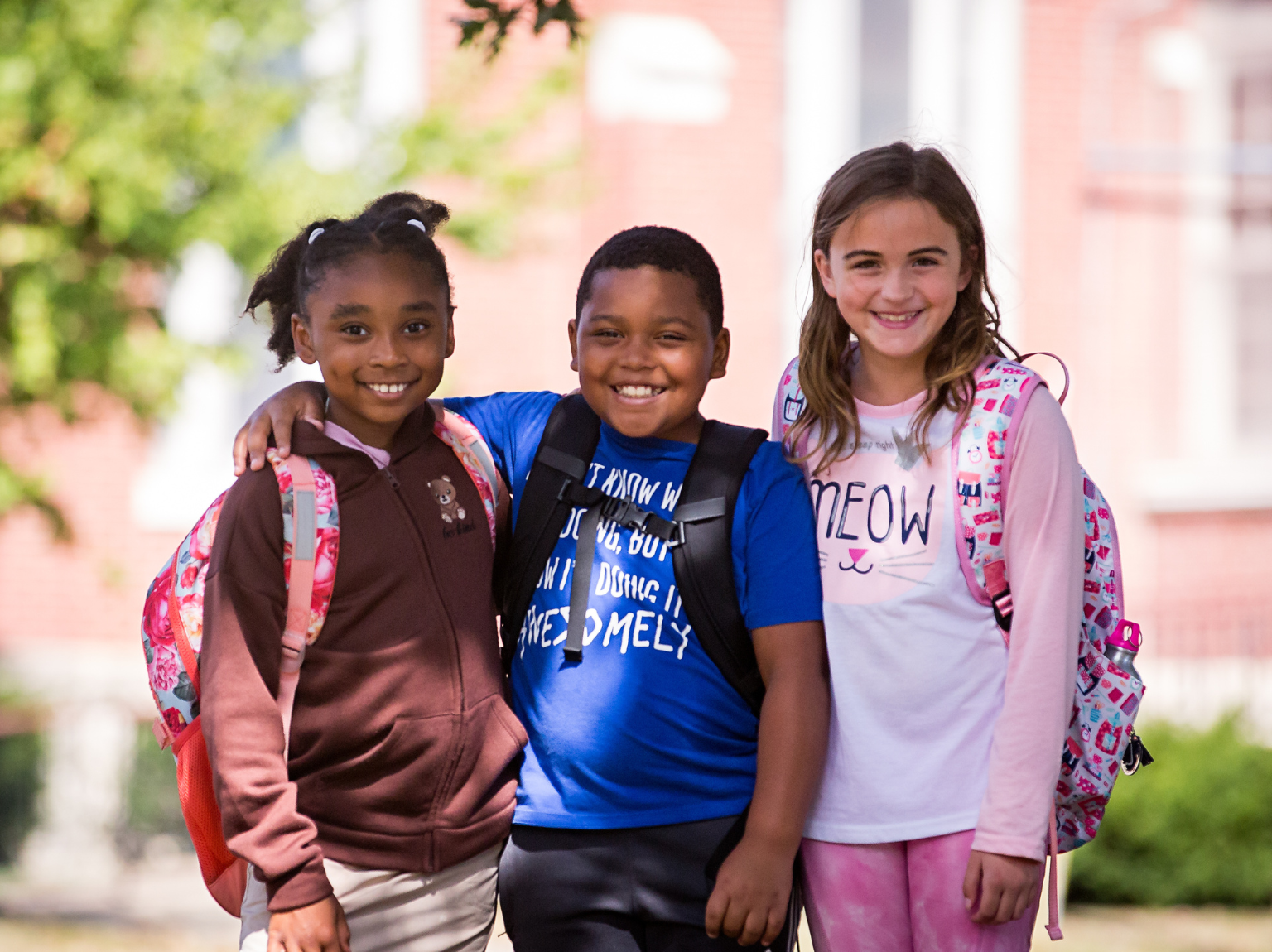 people sitting on chair in front of table while holding pens during daytime